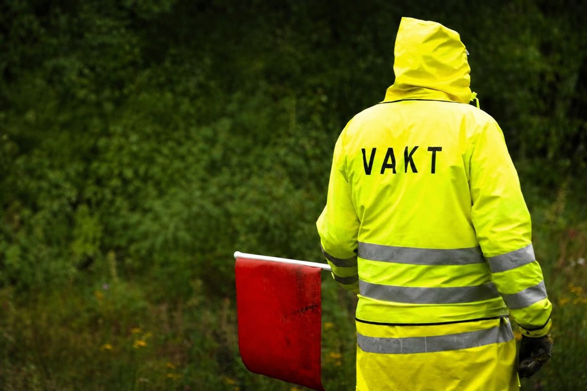 Flaggvakt som dirigerar trafiken vid ett vägarbete i Jönköping